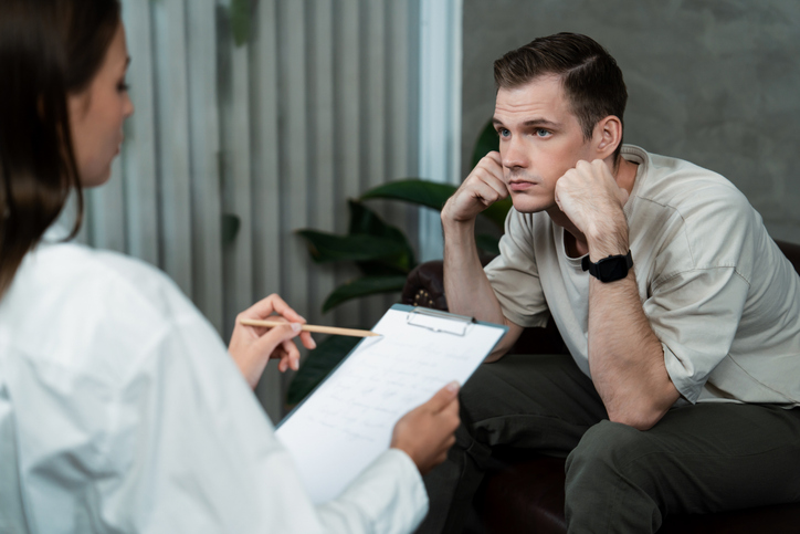 When to see a therapist for depression - stressed patient talking with a counselor